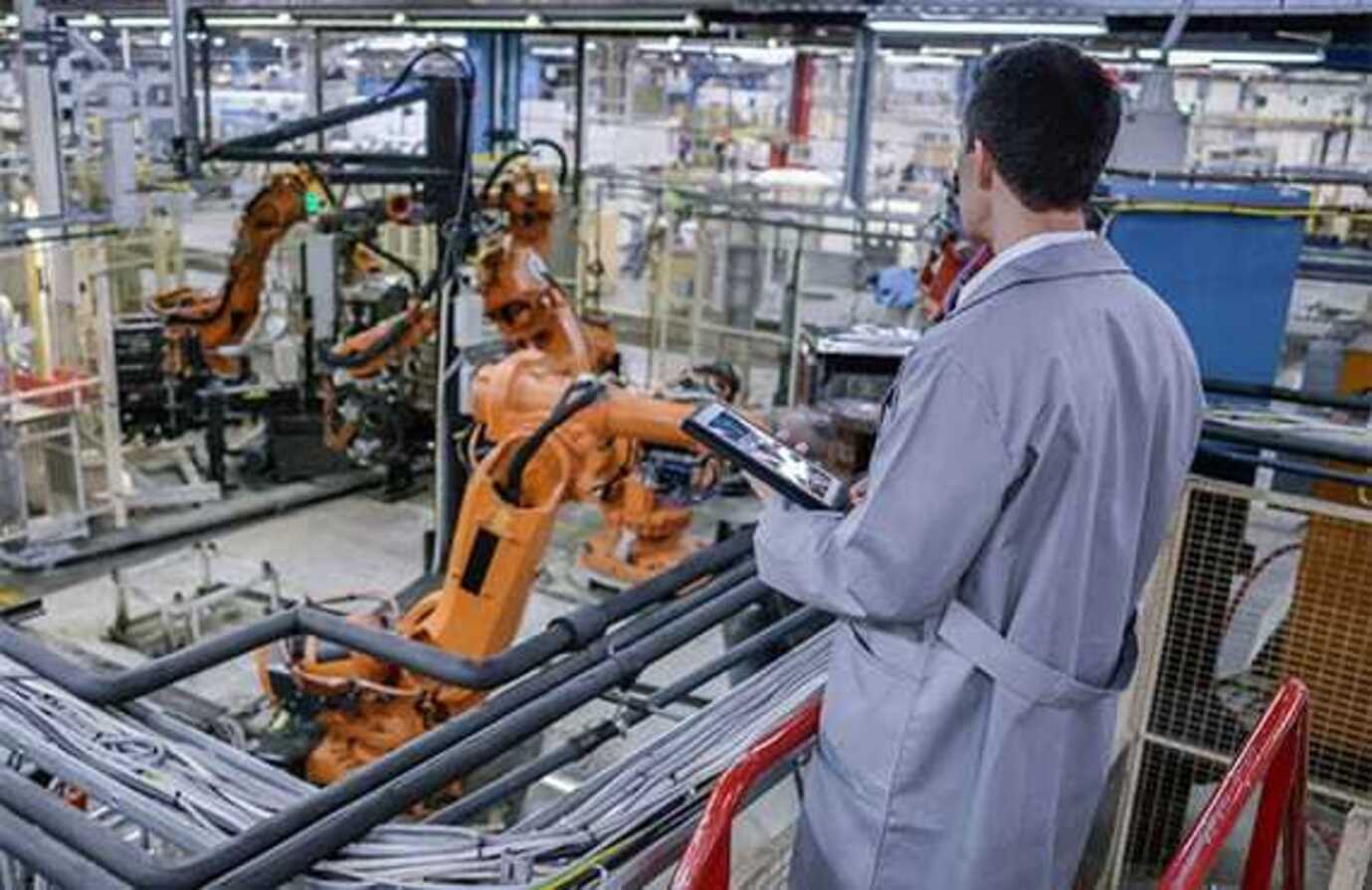 Plant worker holding ipad with Emerson automation solutions