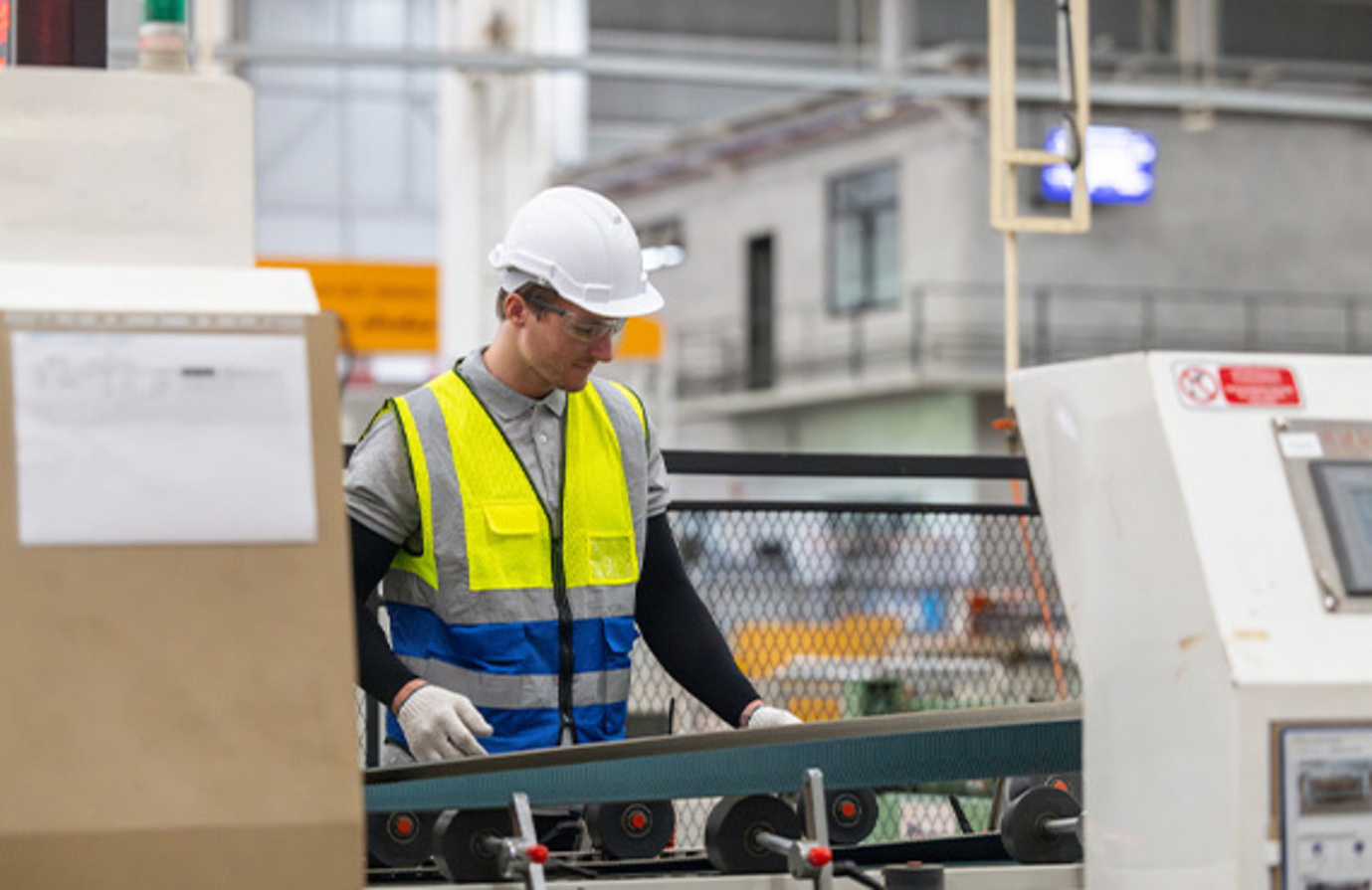 Technician at work in factory, conducting regular inspections, tests, and repairs to uphold optimal machinery condition.