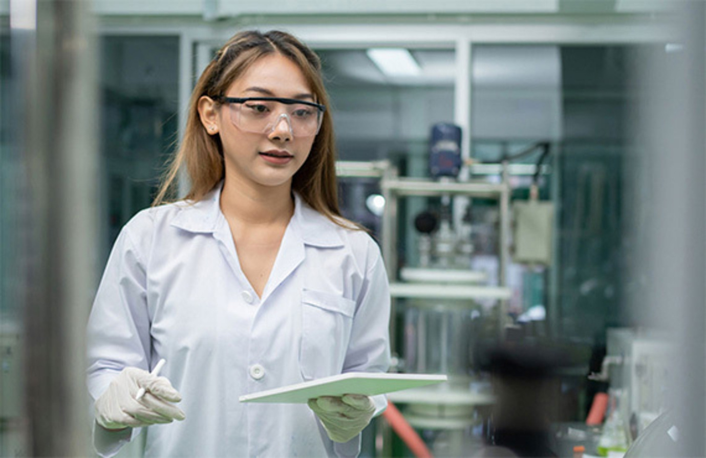 Image displays a laboratory technician using an ipad with a safety instrumented system.