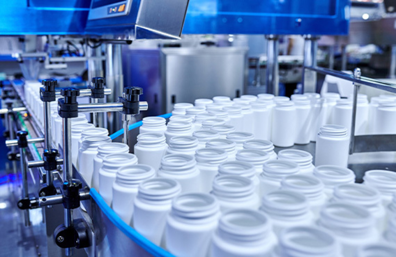 Close-up of pharmaceutical factory's production line using digital transformation and cybersecurity initiatives.