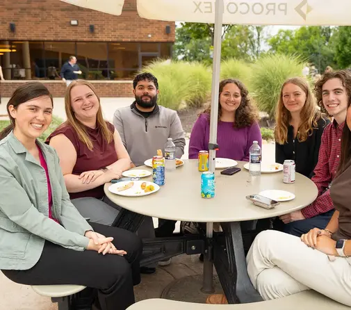 Group of young Proconex employees sitting on the patio