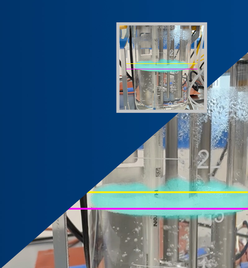 A clear container holding layered clear and light blue liquids with measurement lines overlaid banner
